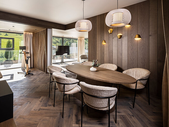 Eleganter Essbereich der Suite 445 mit hochwertiger Holzausstattung und Designleuchten