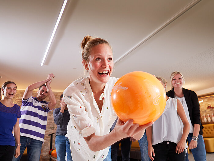 A group enjoys bowling at the Lürzerhof during their active vacation in Austria.