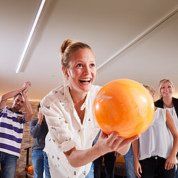 A group enjoys bowling at the Lürzerhof during their active vacation in Austria.