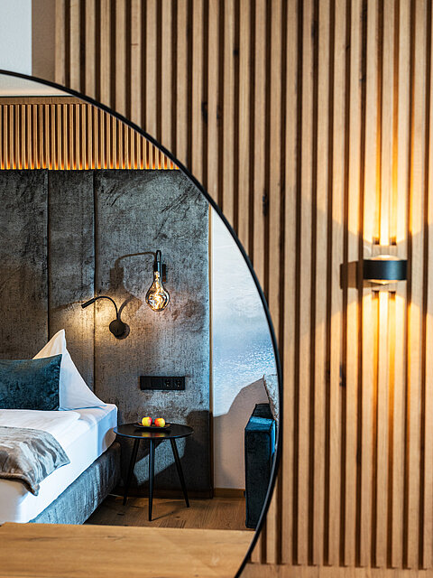 The cozy bed in the Mountain Loft Family Suite at the Lürzerhof