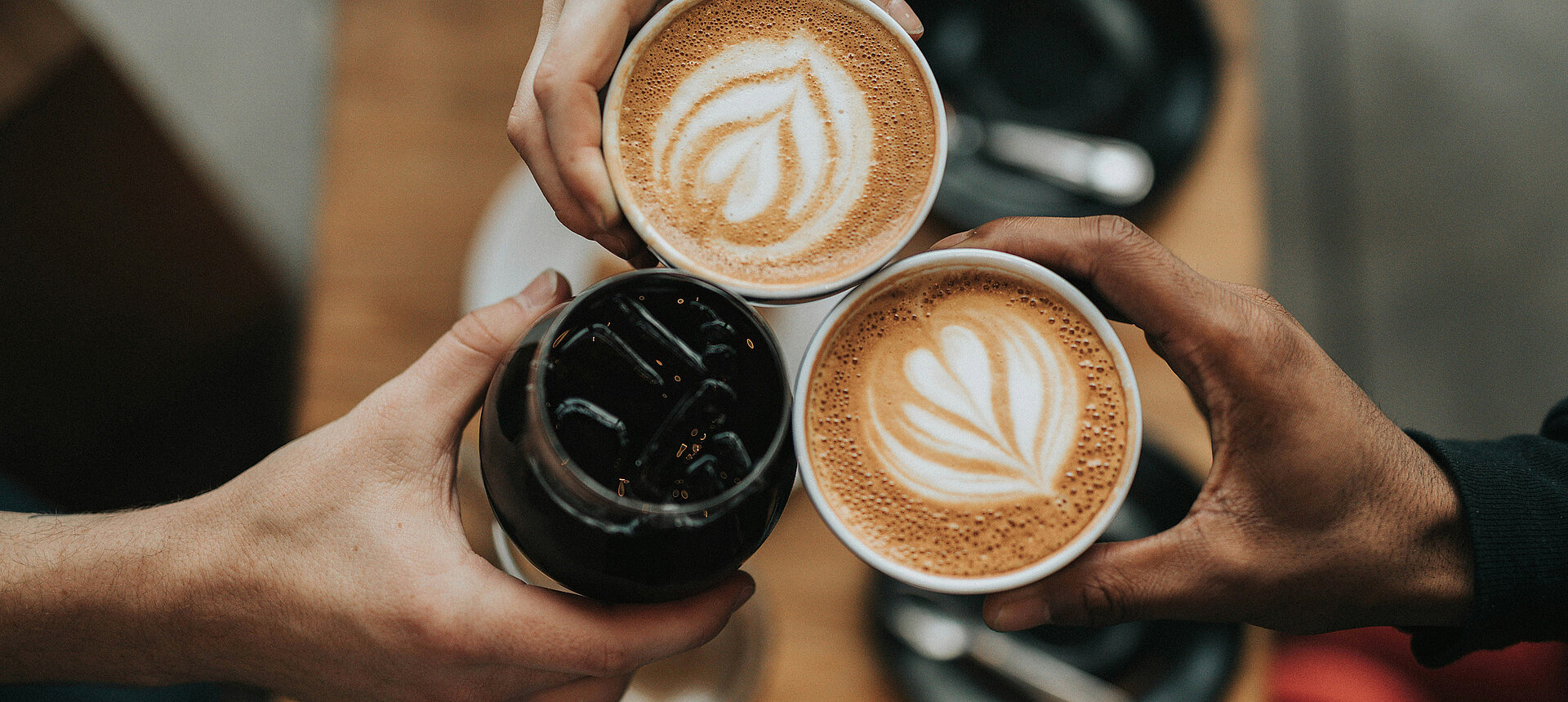 Two cappuccinos and another drink during the Cheers moment