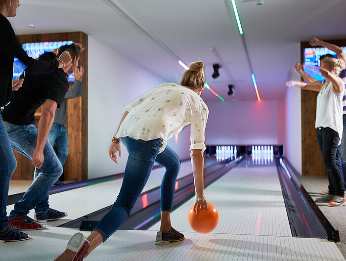 A group enjoys bowling at the Lürzerhof during their active vacation in Austria.