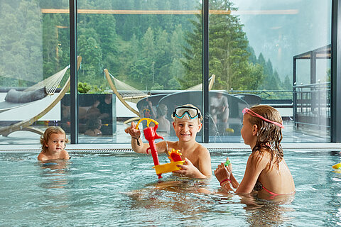 Children splash around in the indoor pool at the Lürzerhof wellness hotel in Salzburg.