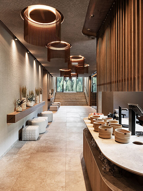 Eleganter Wellnessbereich im Lürzerhof mit Tee- und Erfrischungsstation, natürlichen Materialien und behaglicher Atmosphäre
