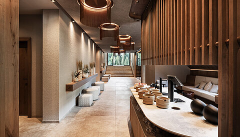 Eleganter Wellnessbereich im Lürzerhof mit Tee- und Erfrischungsstation, natürlichen Materialien und behaglicher Atmosphäre