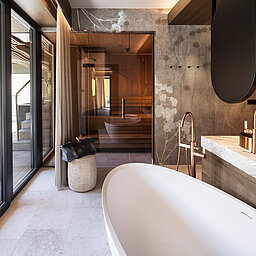 Privates Wellnessbad mit freistehender Badewanne und Sauna in der Suite 445