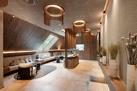 Stilvoller Ruhe- und Erfrischungsbereich im Wellnesshotel Lürzerhof nahe Obertauern mit gemütlichen Sitzplätzen und modernem Holzdesign