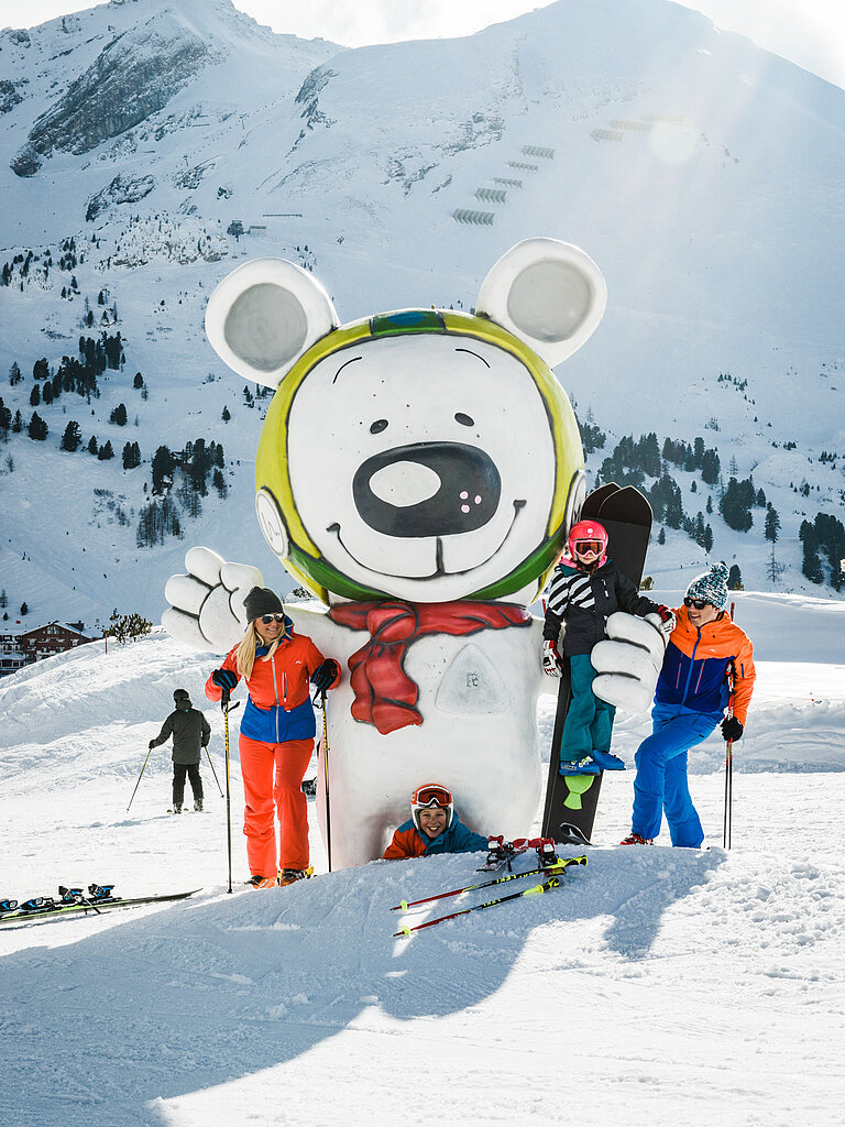 Family having fun in the snow on an active vacation in Austria